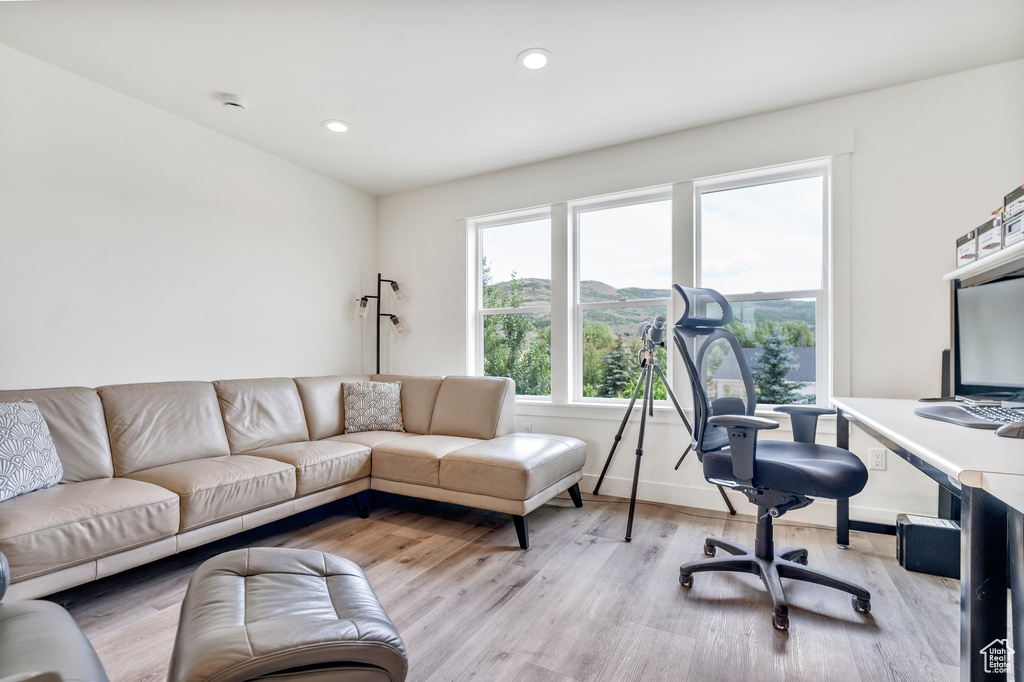 Home office with light wood-style floors, recessed lighting, and baseboards