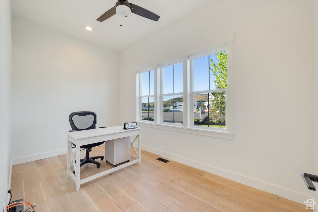 Home office with baseboards, healthy amount of natural light, a ceiling fan, light wood-style floors, and recessed lighting