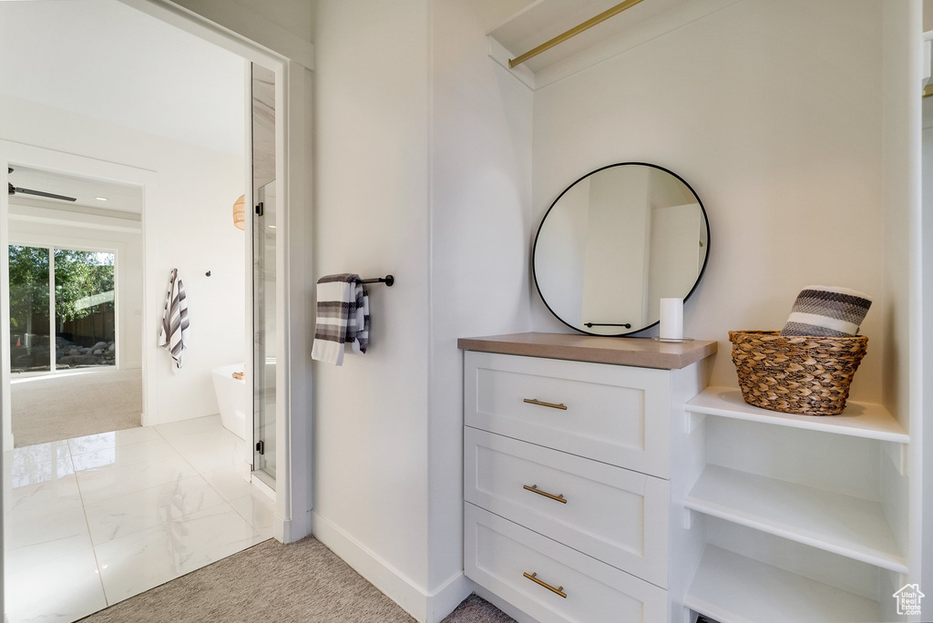 Full bath featuring a shower stall and baseboards