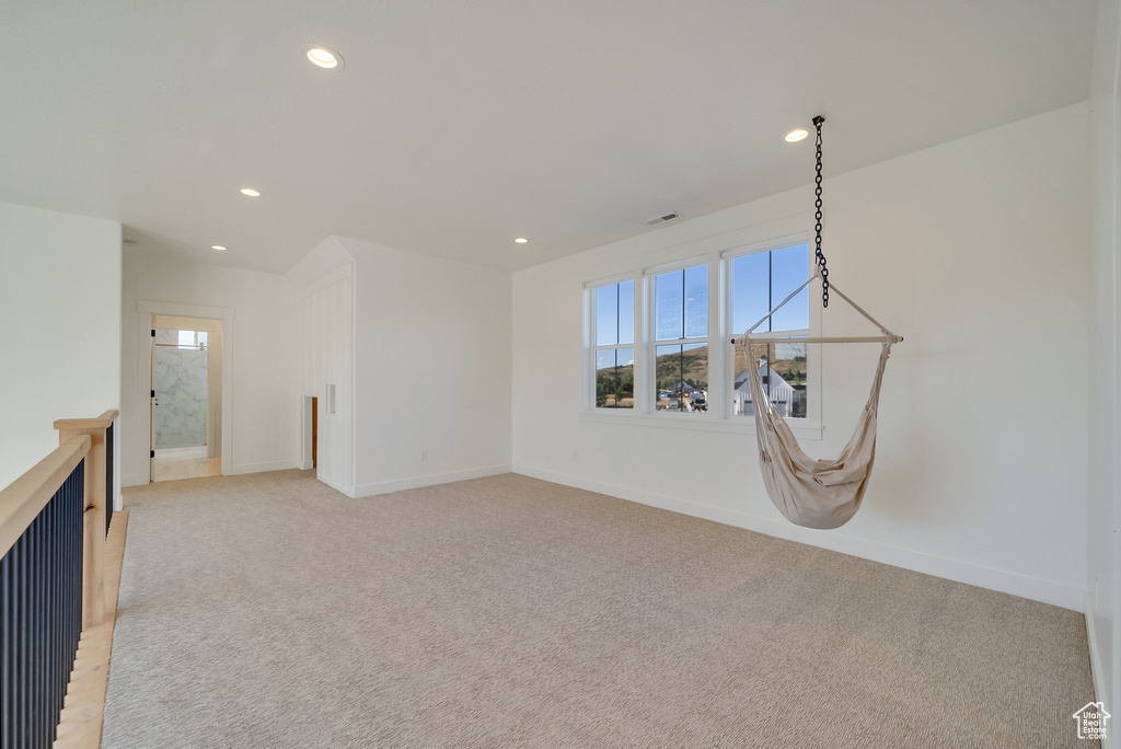 Unfurnished room featuring light colored carpet, recessed lighting, and baseboards