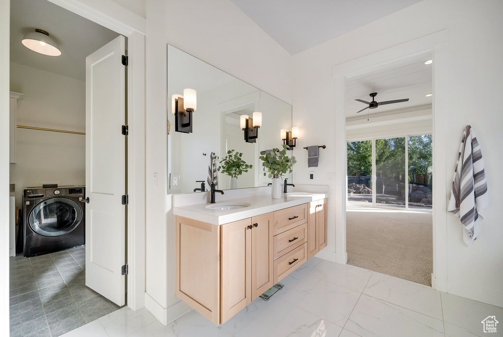 Bathroom with washer / dryer, ceiling fan, and double vanity