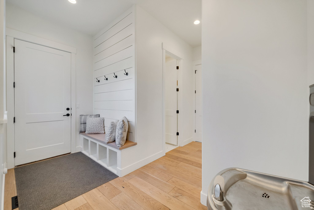 Mudroom featuring light wood-type flooring, recessed lighting, and baseboards