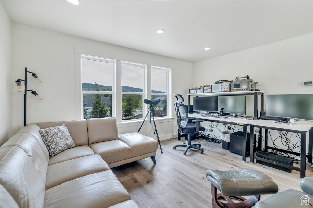 Home office featuring wood finished floors, recessed lighting, and baseboards
