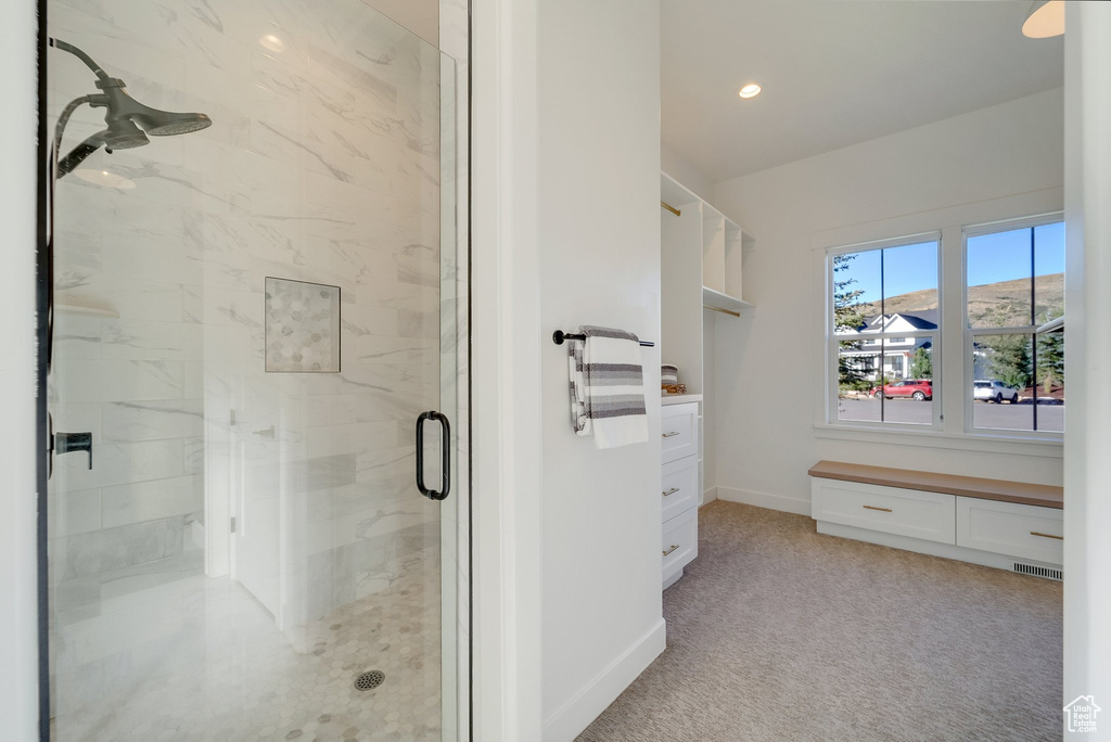 Full bath with a marble finish shower, baseboards, recessed lighting, and vanity