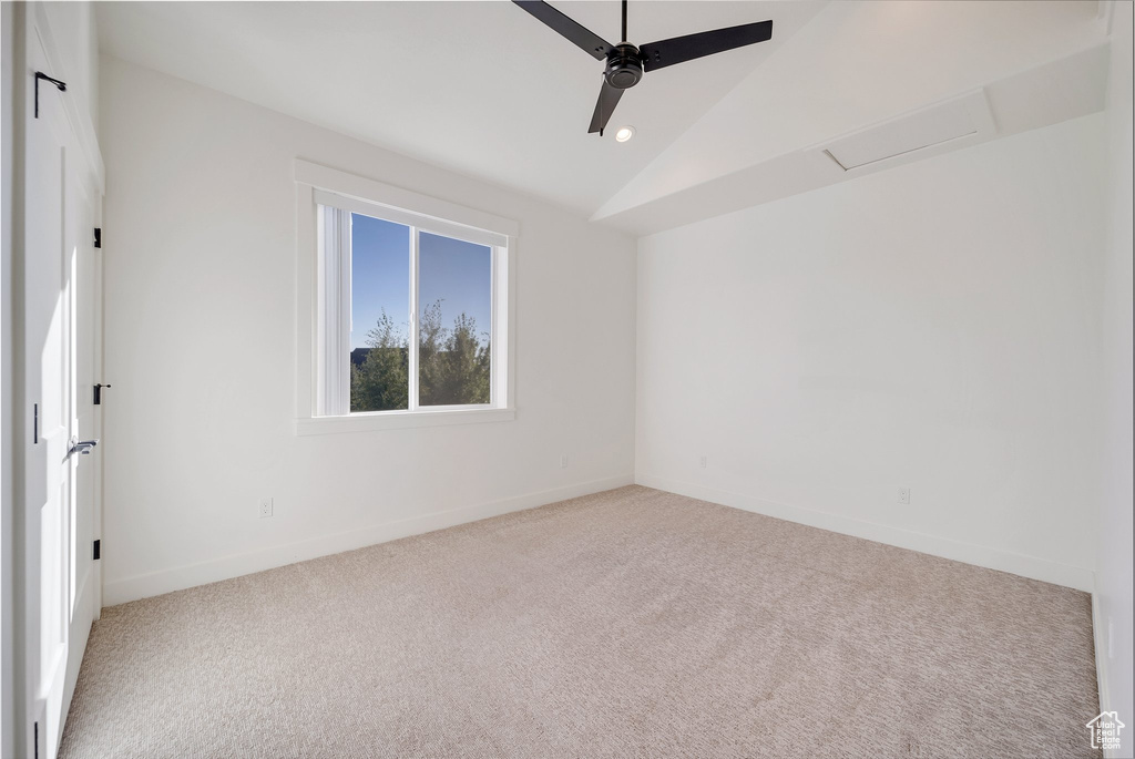 Carpeted spare room with lofted ceiling, a ceiling fan, baseboards, and recessed lighting