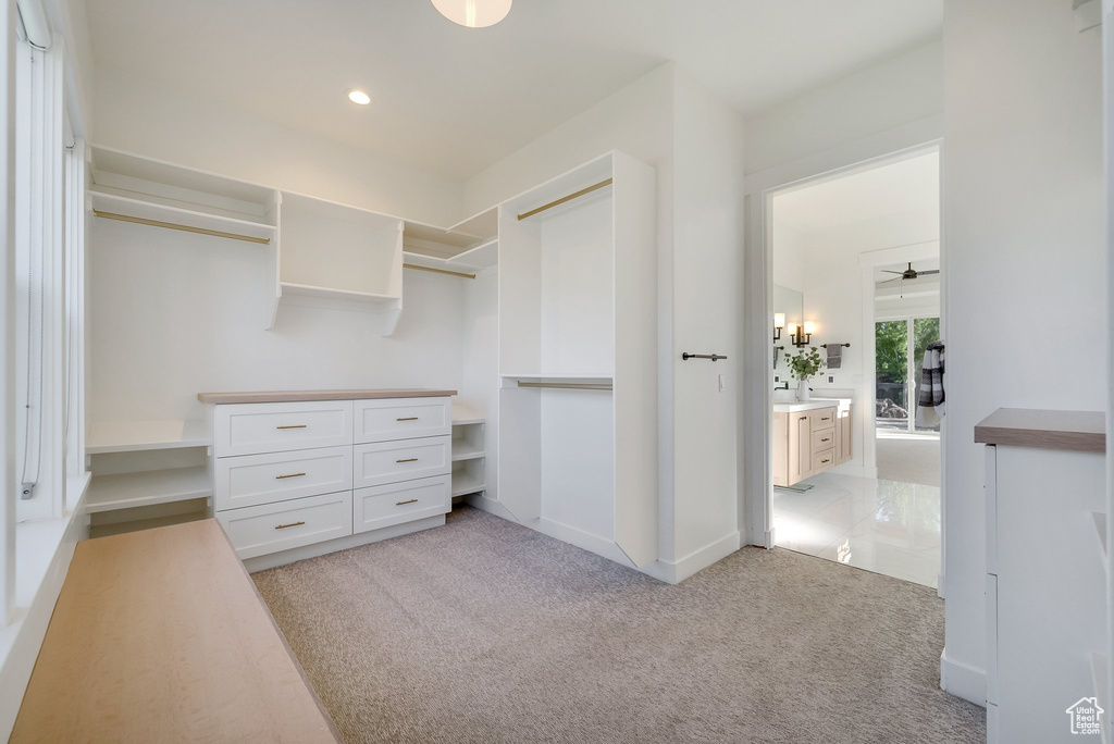 Walk in closet featuring light carpet