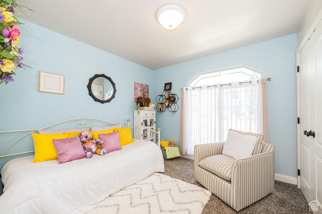 Carpeted bedroom featuring baseboards
