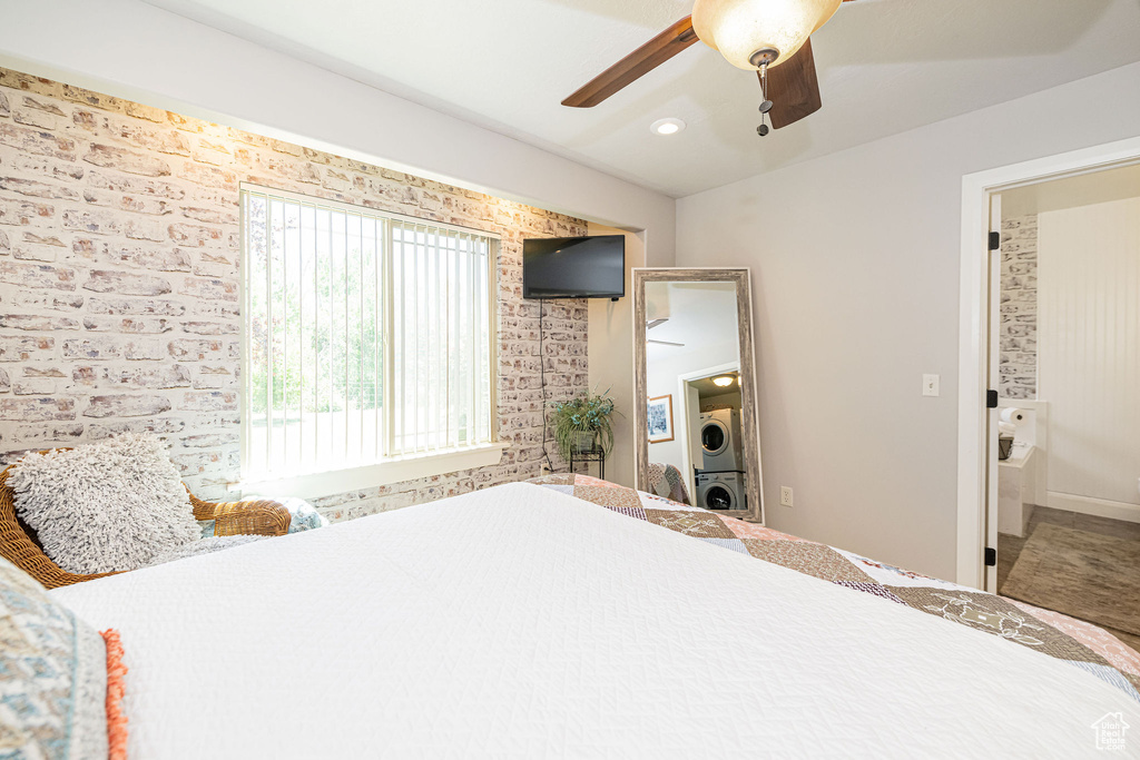 Bedroom with stacked washing machine and dryer, ceiling fan, and recessed lighting