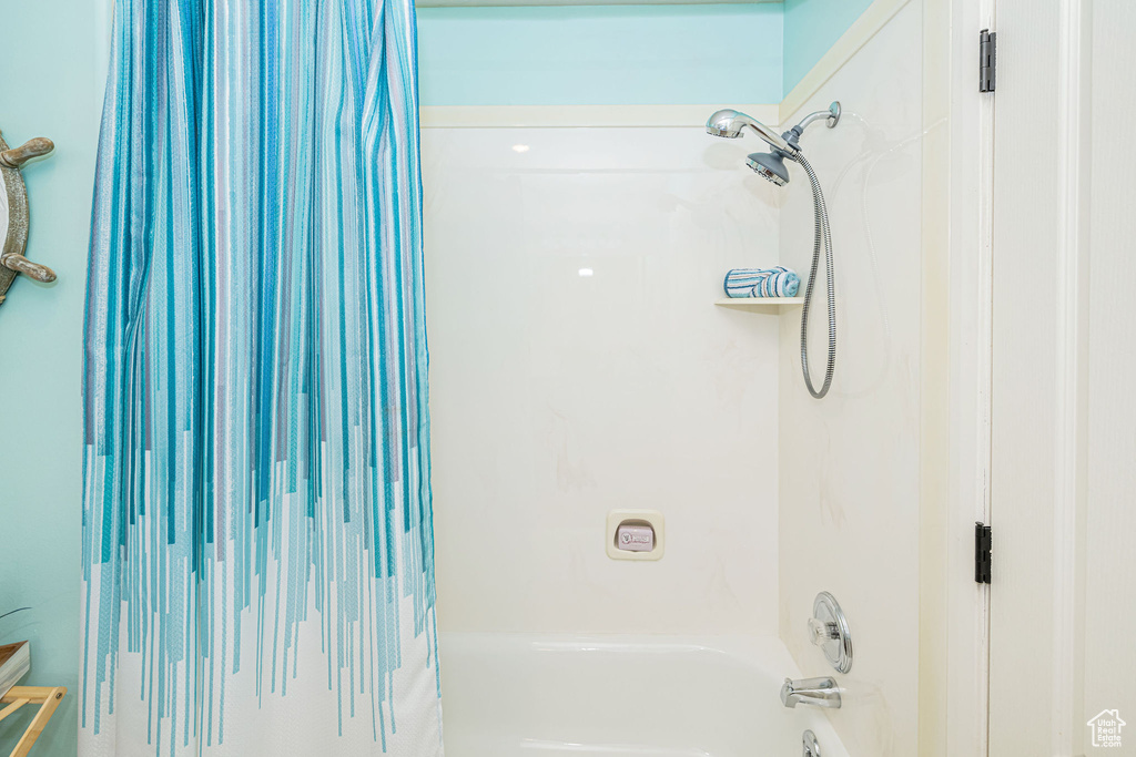 Bathroom featuring shower / bathtub combination with curtain