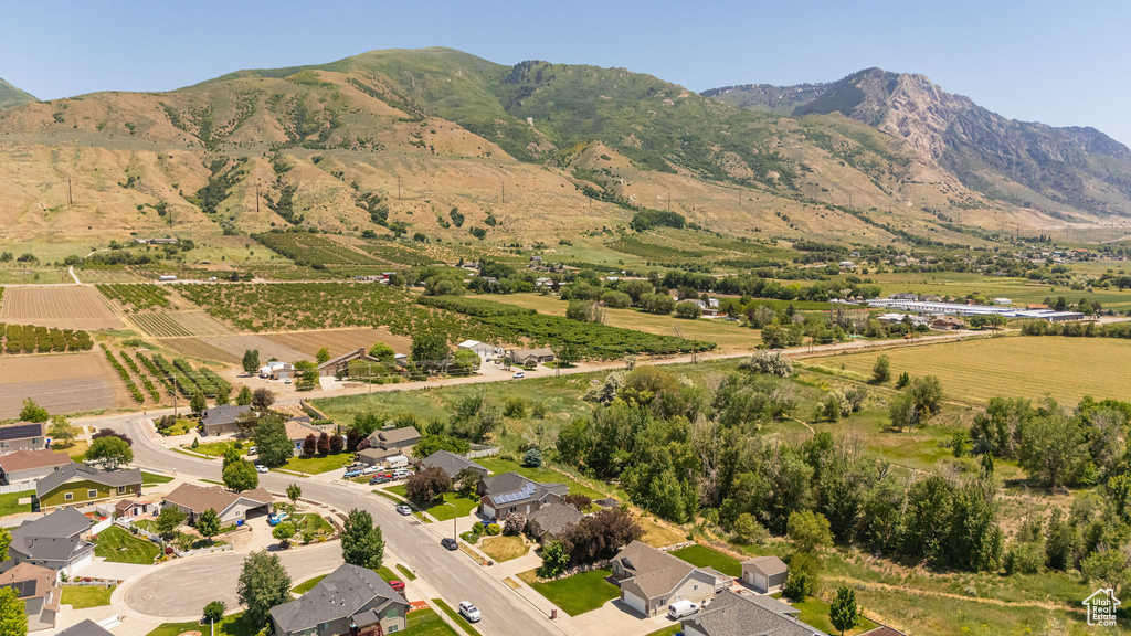 Aerial view of property's location featuring rural landscape, extensive farmland, and a mountainous background