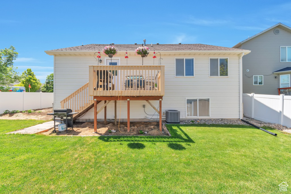 Back of house with central AC, a wooden deck, and stairs