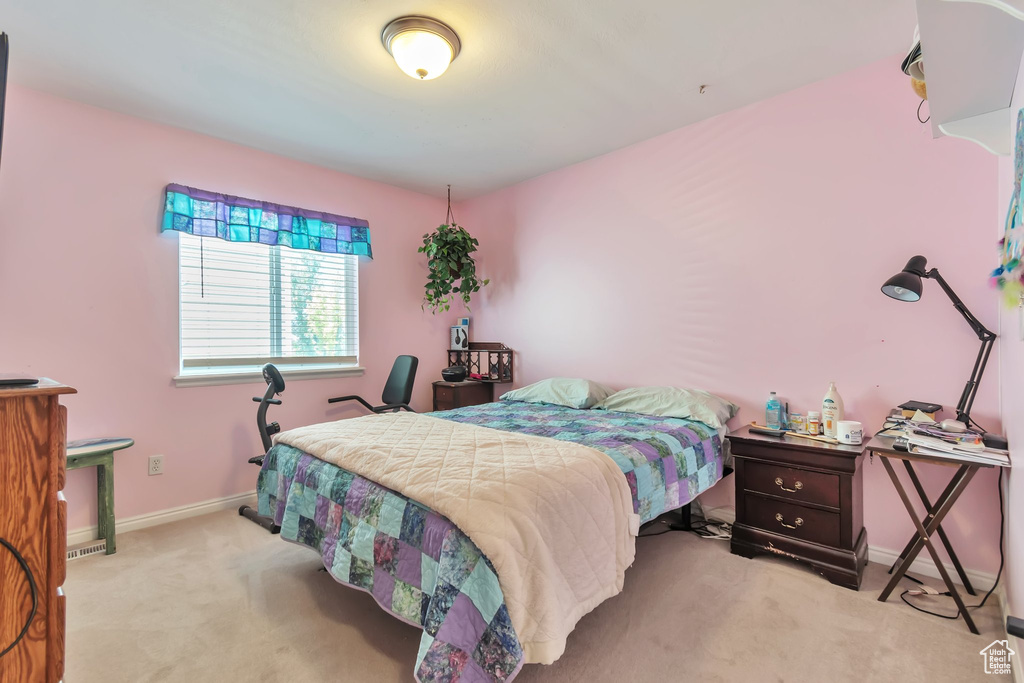 Bedroom featuring light colored carpet and baseboards