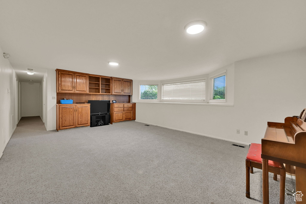 Office space featuring light colored carpet and baseboards