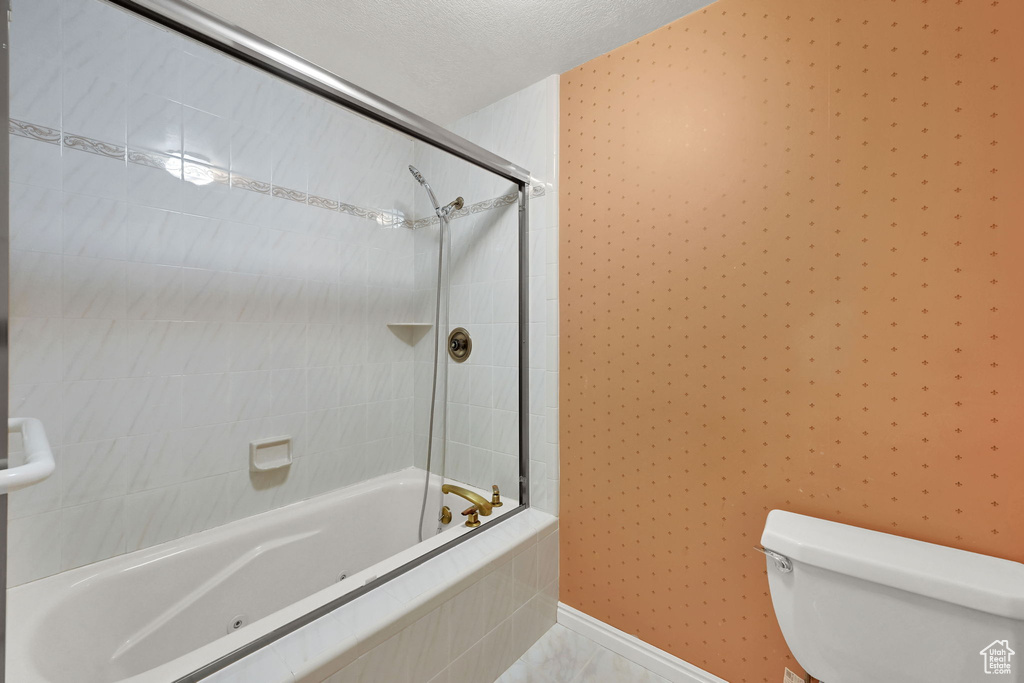 Full bathroom featuring toilet and tiled shower / bath
