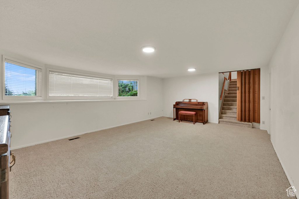 Basement featuring stairs, carpet, and recessed lighting