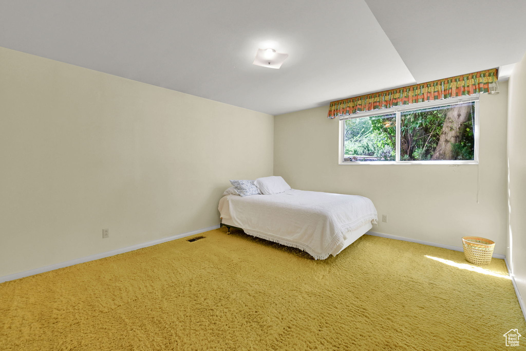 Carpeted bedroom with baseboards
