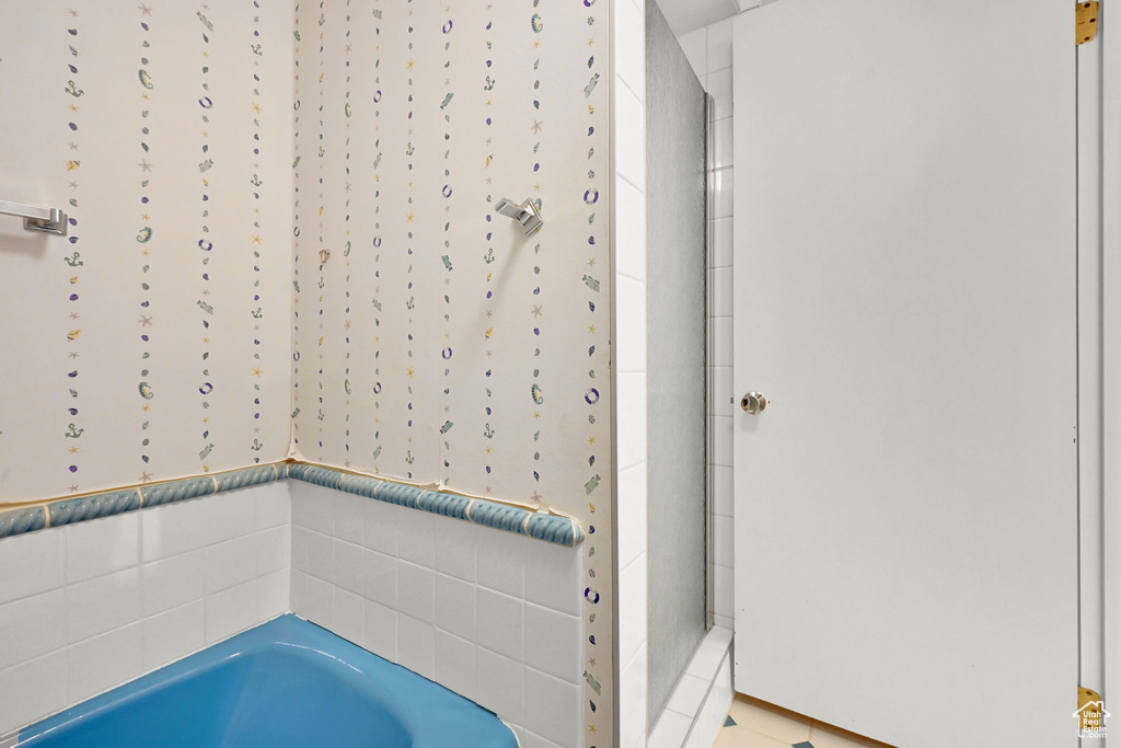 Bathroom with a bath and tiled shower