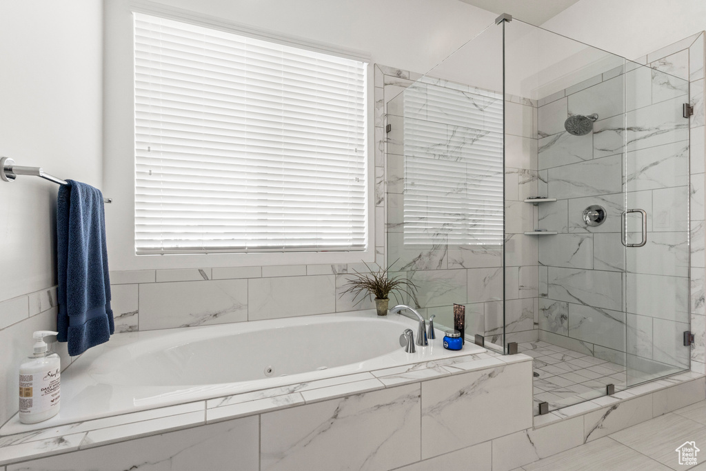 Bathroom with a shower stall and a garden tub