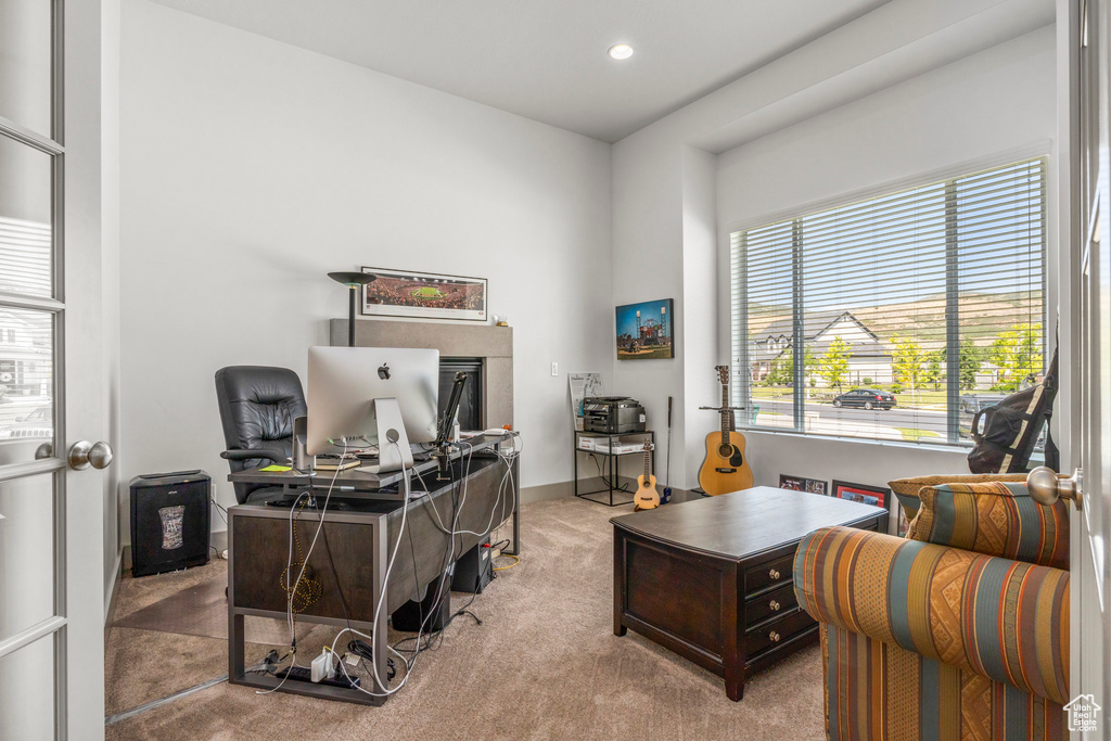 Carpeted office with recessed lighting and baseboards