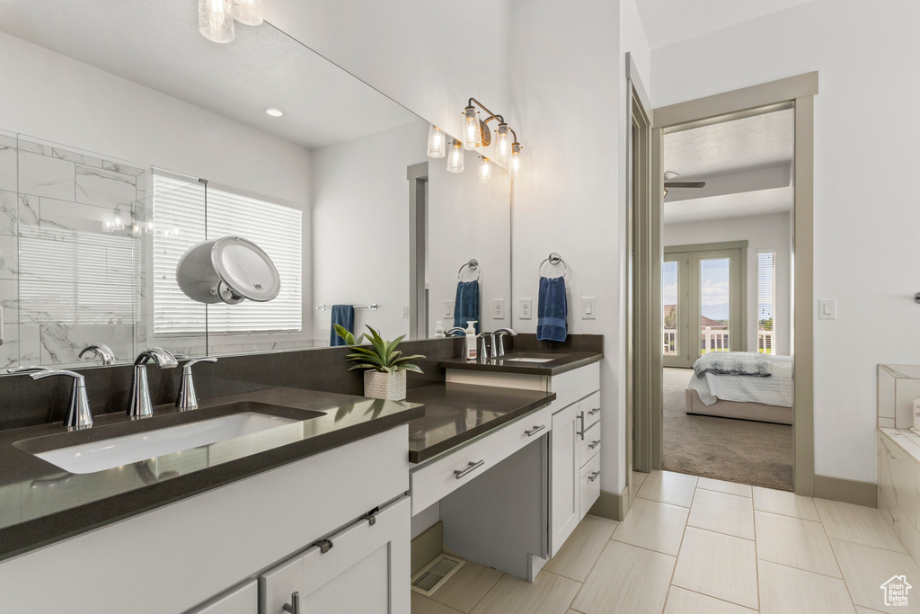 Full bath featuring ensuite bath, double vanity, a shower with door, recessed lighting, and ceiling fan