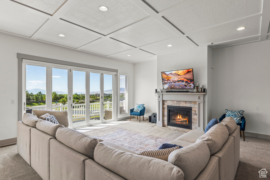 Living area featuring carpet, coffered ceiling, a fireplace, recessed lighting, and baseboards