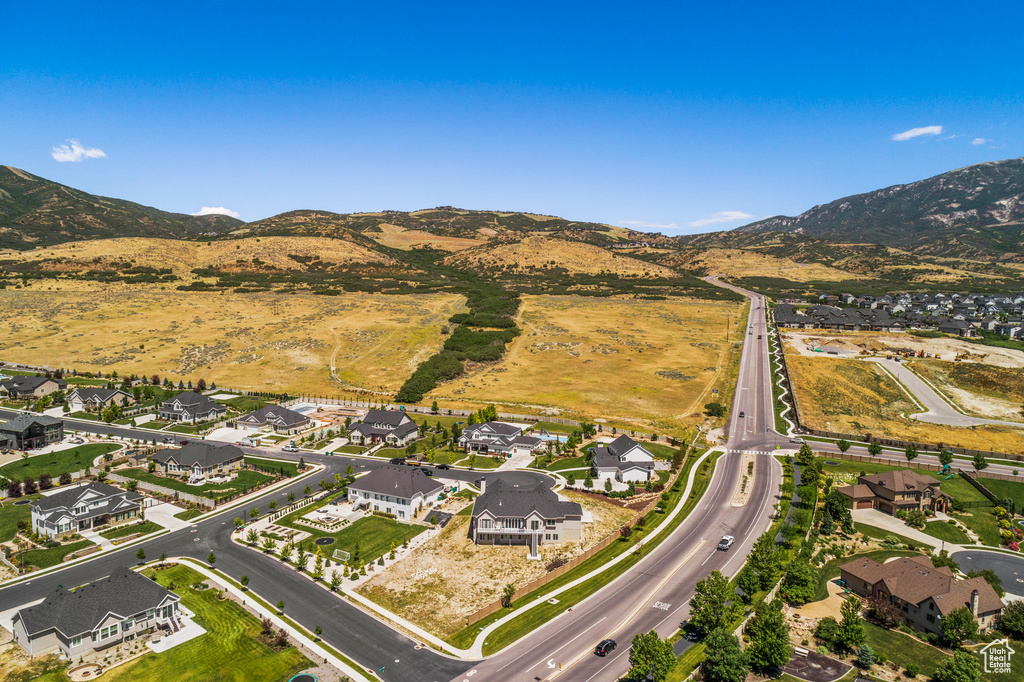 Aerial overview of property's location with mountains and nearby suburban area