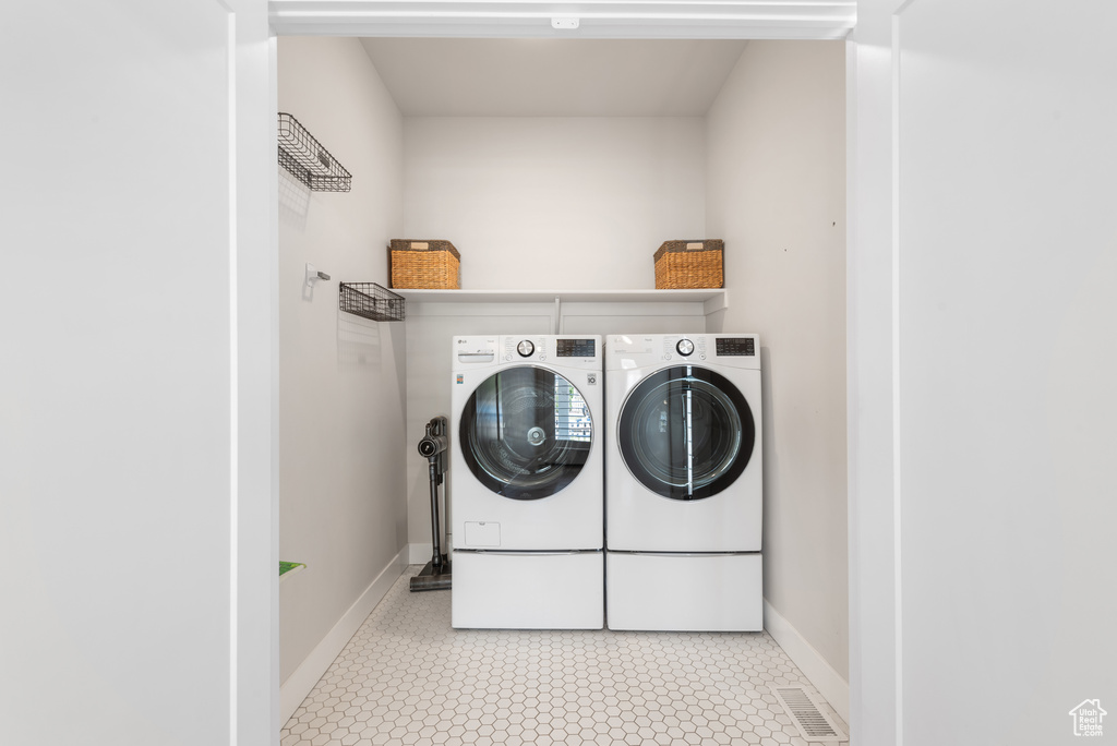 Laundry area with washing machine and dryer and baseboards