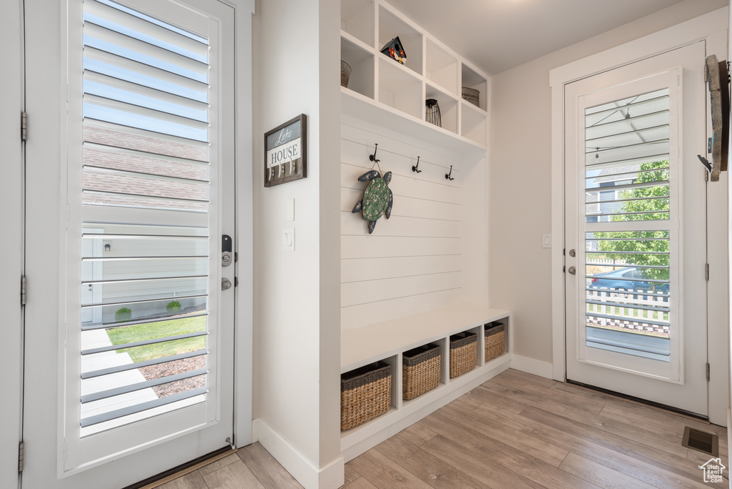 Mudroom with light wood-style flooring and baseboards