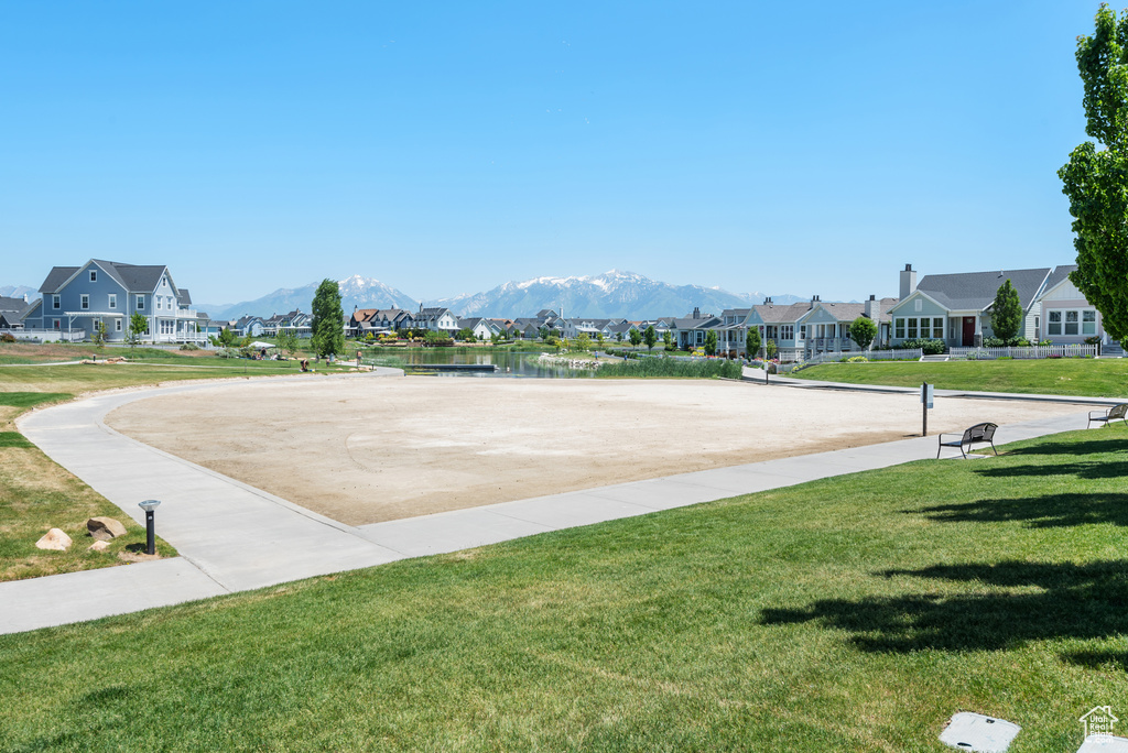 View of community with a residential view, a yard, and a mountain view
