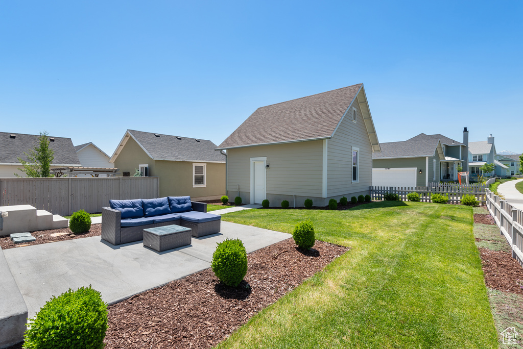Rear view of property featuring outdoor lounge area, a patio area, roof with shingles, and a residential view