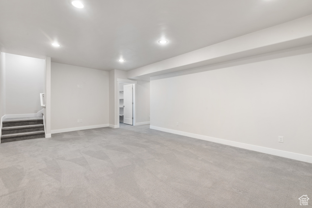 Finished below grade area with recessed lighting, stairway, carpet, and baseboards