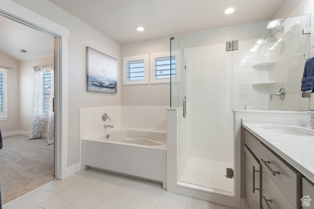 Full bath featuring a garden tub, a shower stall, vanity, recessed lighting, and baseboards