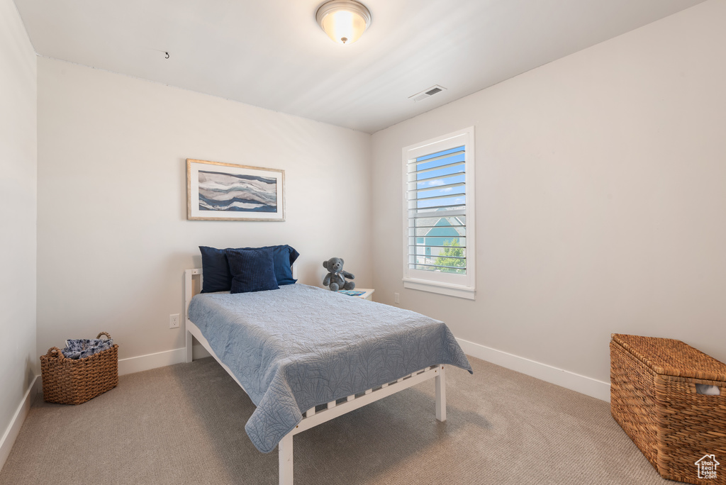Carpeted bedroom with baseboards