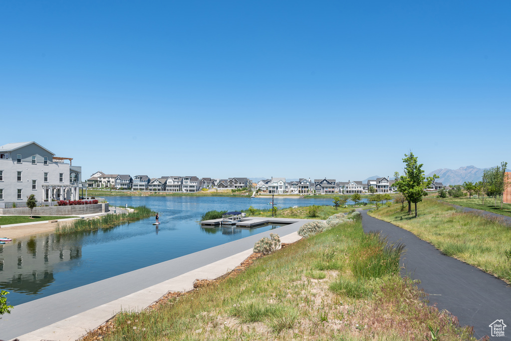 Water view with nearby suburban area and a dock