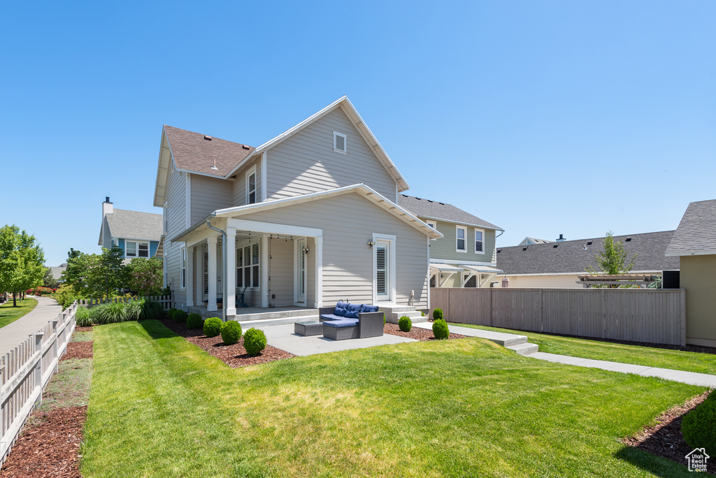 Back of property with a patio and an outdoor hangout area