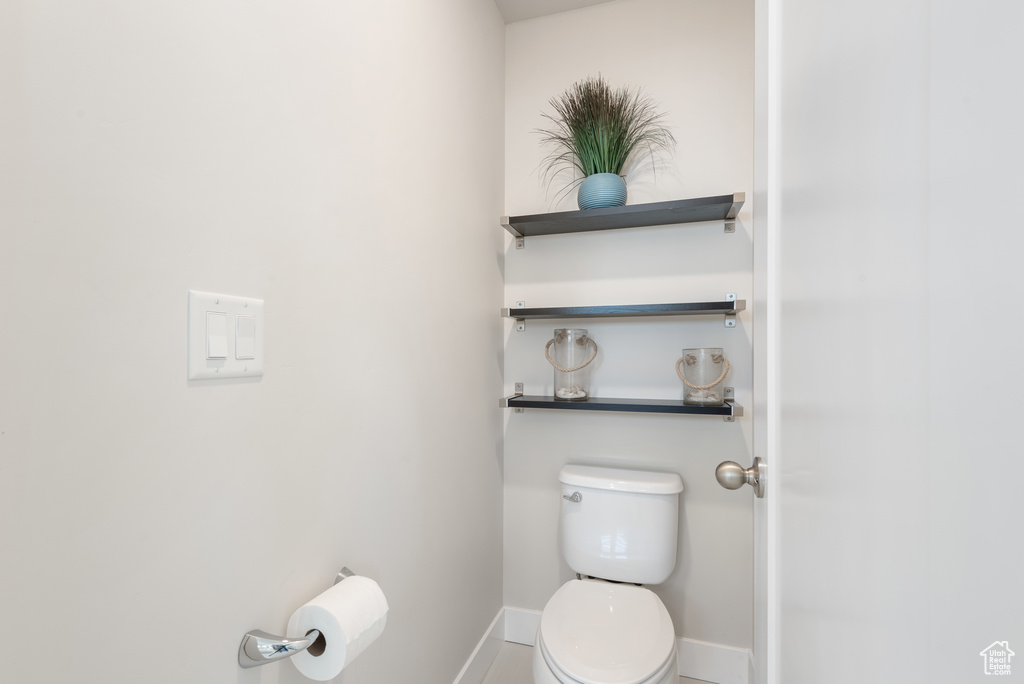 Bathroom with toilet and baseboards