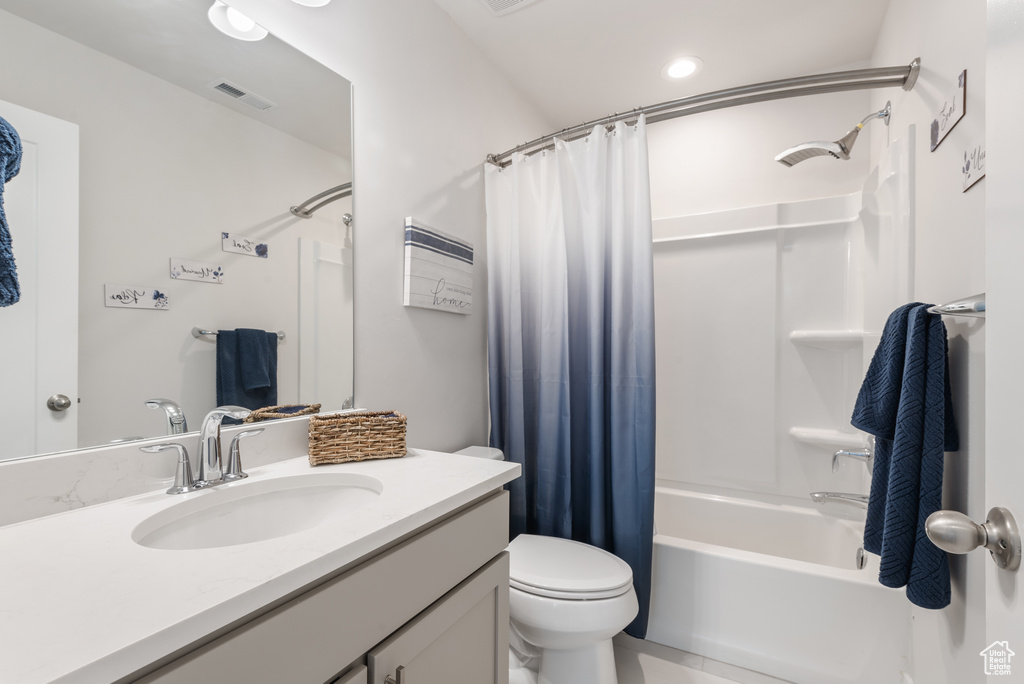 Full bath featuring vanity, shower / tub combo with curtain, and toilet
