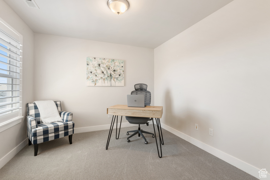 Carpeted office featuring baseboards