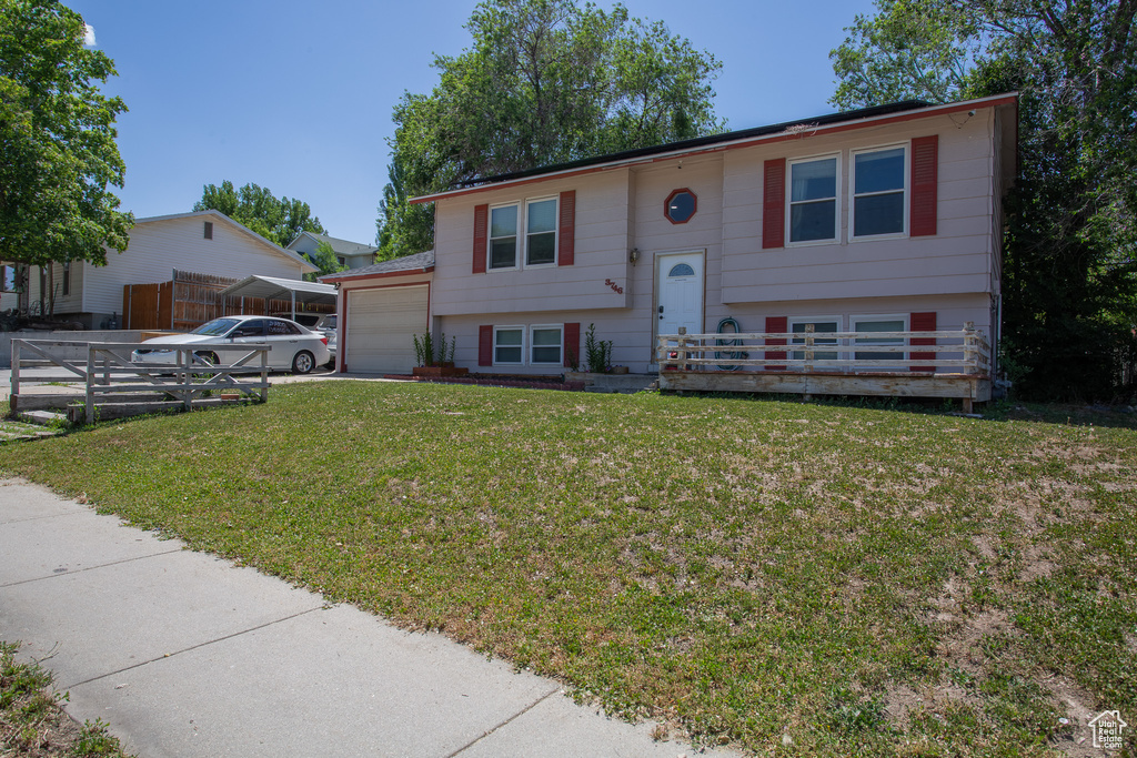 Split foyer home featuring a garage and driveway