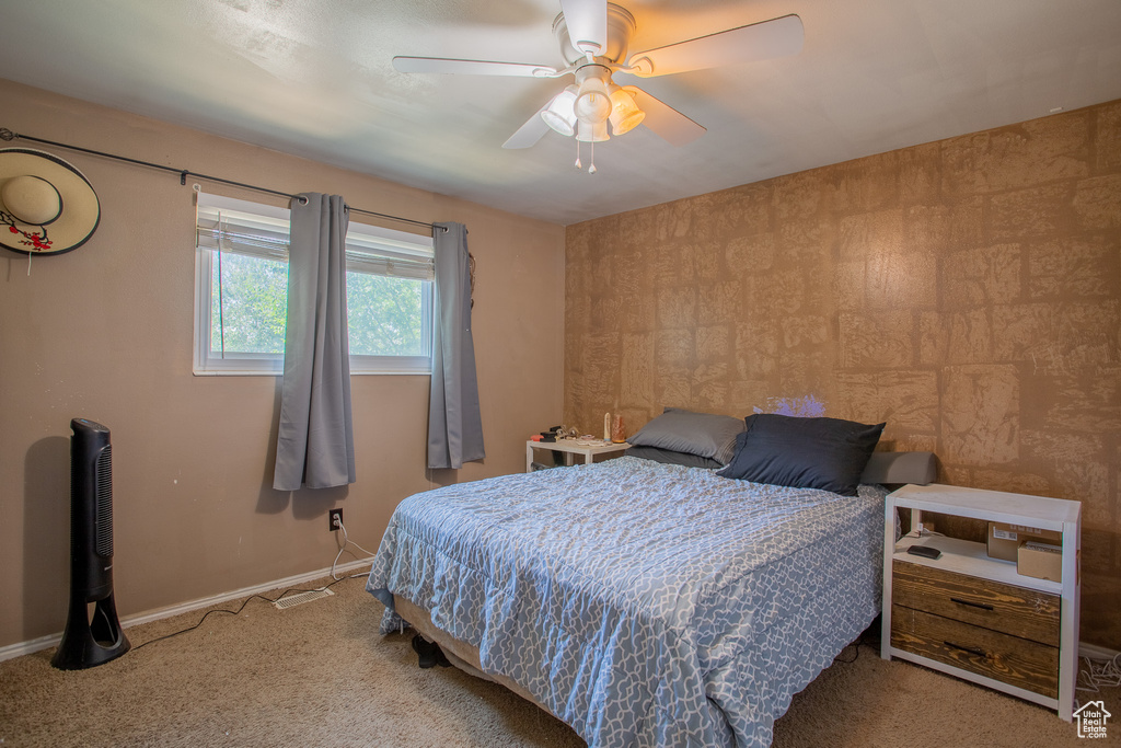 Bedroom with carpet flooring, baseboards, and a ceiling fan