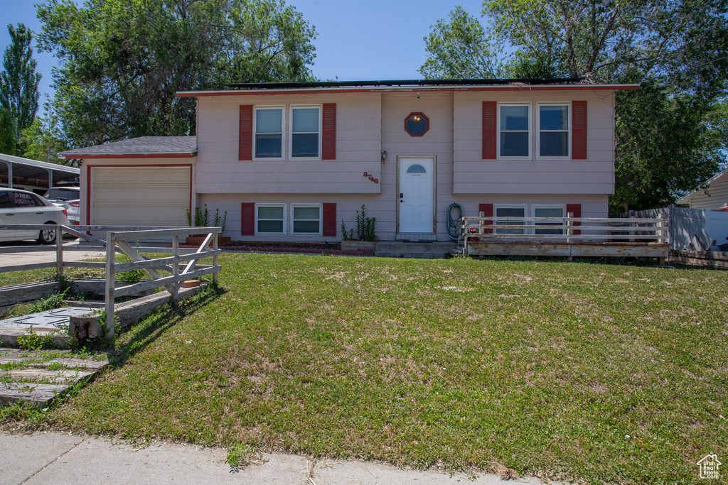 Split foyer home with a garage and driveway