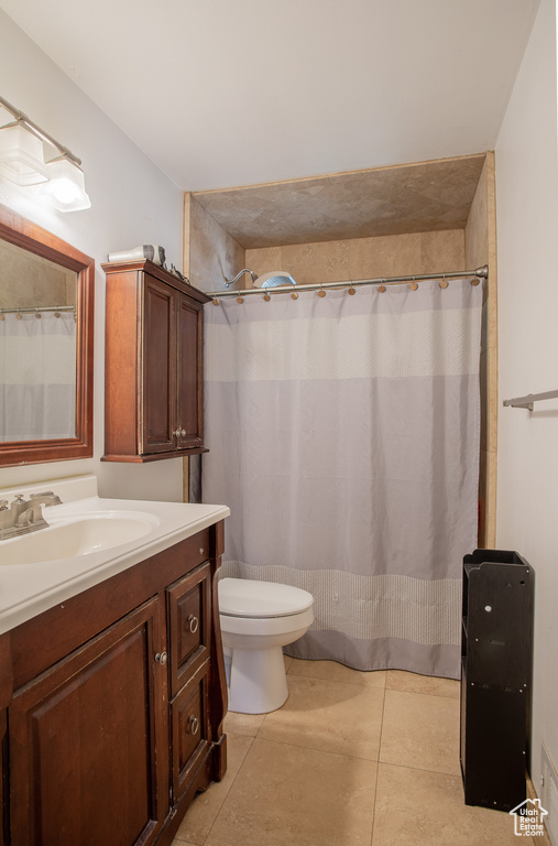 Bathroom featuring vanity, toilet, tile patterned flooring, and a shower with curtain