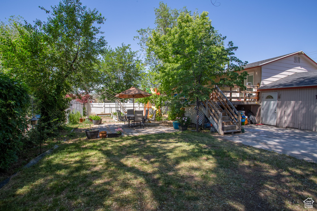 View of yard with a patio, stairway, and a deck
