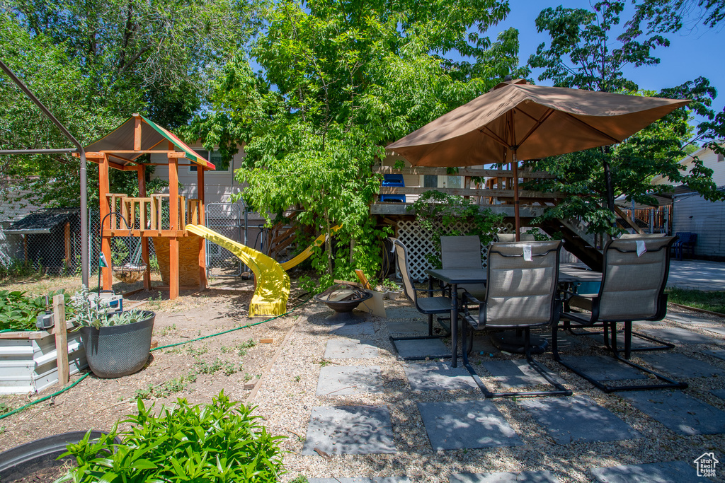 View of patio / terrace featuring a playground and outdoor dining area