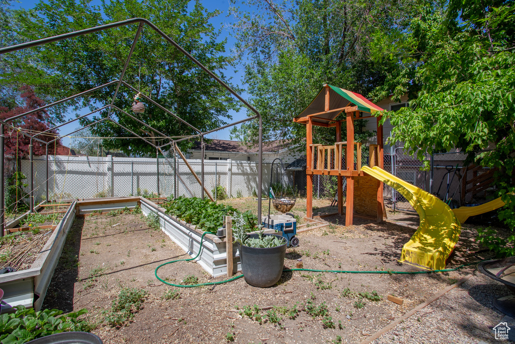 View of playground with a garden