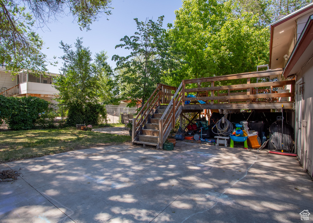 View of patio featuring stairway and a deck