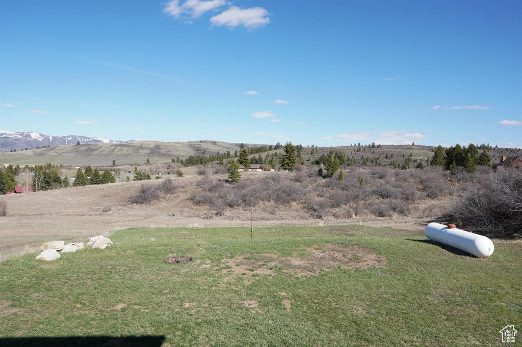 View of green lawn featuring a mountain view