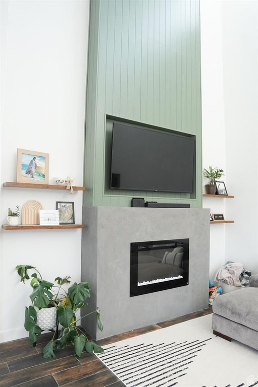 Living area with wood finished floors and a large fireplace