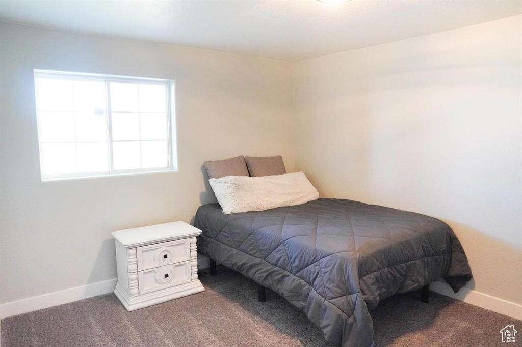 Carpeted bedroom with baseboards