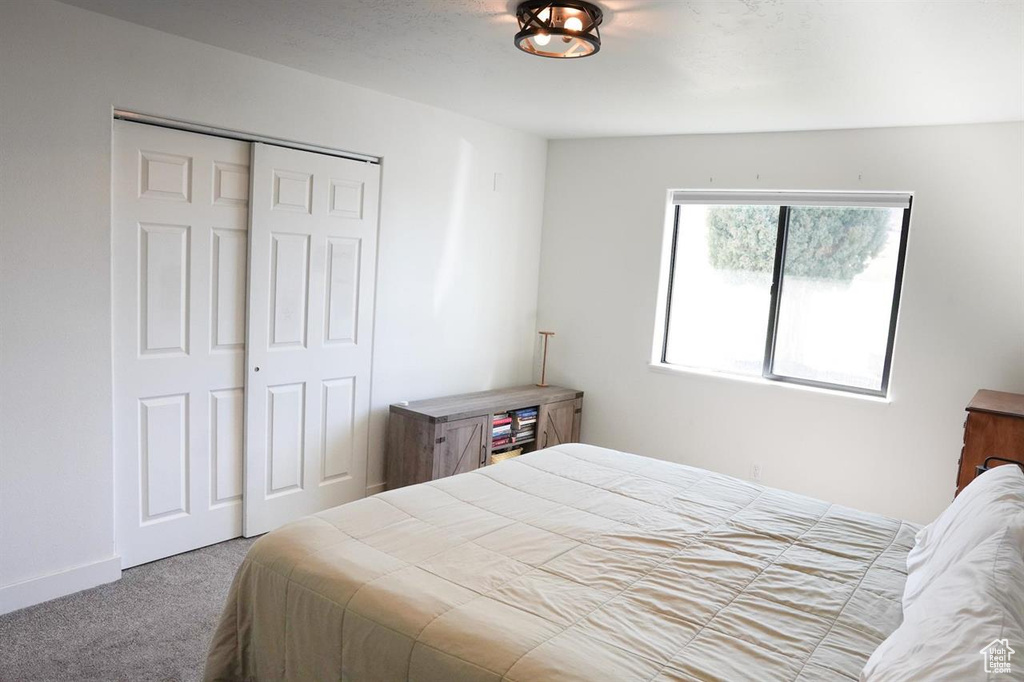 Bedroom with carpet and a closet